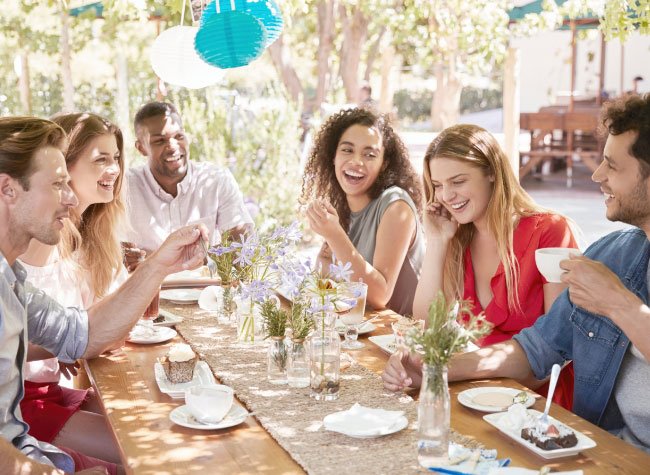 six-young-friends-dining-at-a-table-outdoors-2021-04-02-20-00-42-utc
